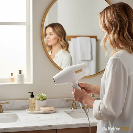 Tia's Treasure Collections Babyliss 4Barber white professional hair dryer held by a woman in a bright bathroom