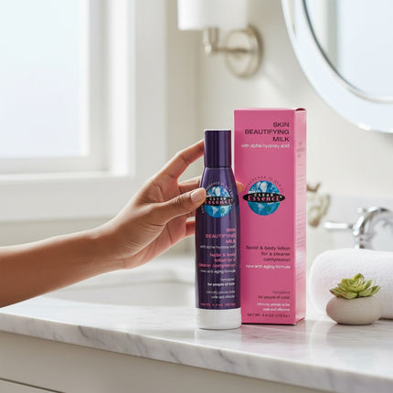 Tia's Treasure Collections Clear Essence Alpha Hydroxy Skin Beautifying Milk 4 oz bottle and box on a bathroom counter.