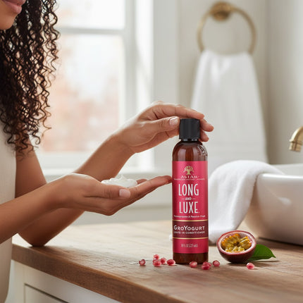 Tia's Treasure Collections As I Am Long and Luxe GroYogurt leave-in conditioner bottle with cream in a hand