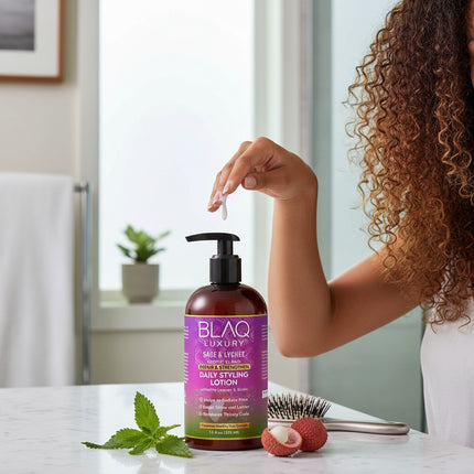 Tia's Treasure Collections Blaq Luxury Sage and Lychee daily styling lotion bottle on a bathroom counter.